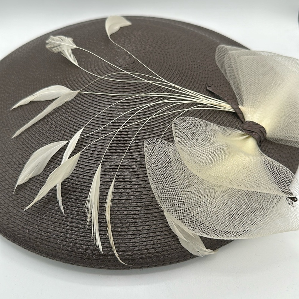 Stunning brown straw hat with cream bow and feather stems